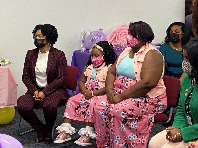 Photo of SW Tomi Handy sitting with Alivia and Ms. Martin