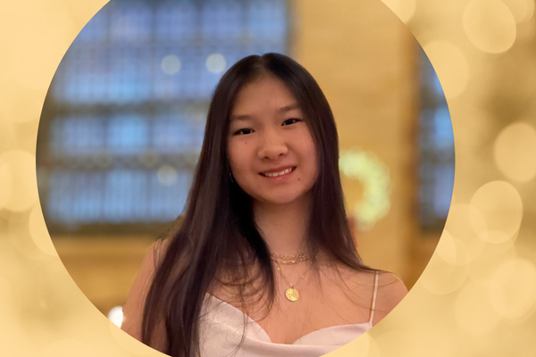 A a portrait of a young women with long straight dark hair with a blurred background. 