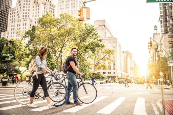 People with bicycle crossing roads