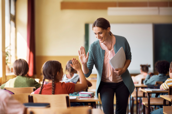Teacher high-fiving student