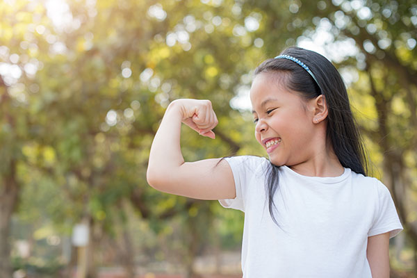 young girl flexing muscle